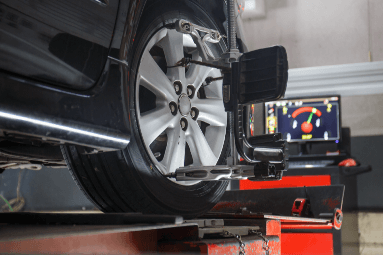 car tire rotation check with a monitor showing results in the background